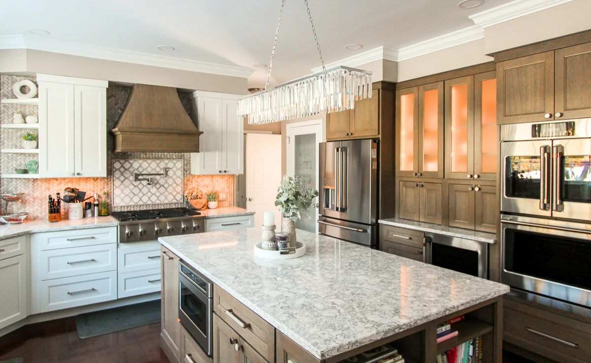 Phoenixville kitchen remodel with white and wood cabinetry, a large island and integrated appliances