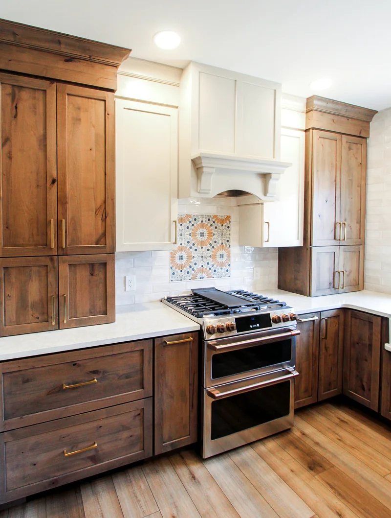 Custom wood cabinetry with white range hood in a Philadelphia kitchen remodel by dRemodeling